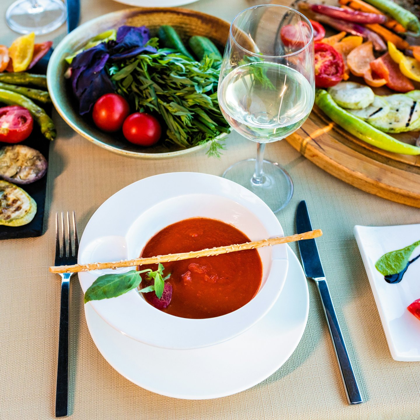 Tomatensoep met groenten en een glas witte wijn